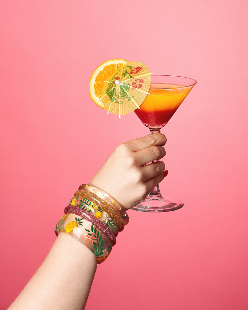 Splendette vintage inspired 1950s retro tropical style Pineapple fakelite jewellery with hand model holding a drink