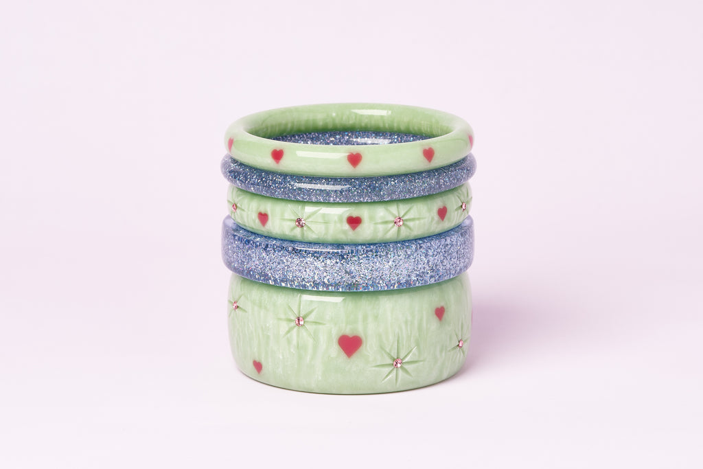 Splendette vintage inspired 1950s Valentine's inspired carved pastel green Sweet Pea bangles stacks with Powder Blue Glitter bangles