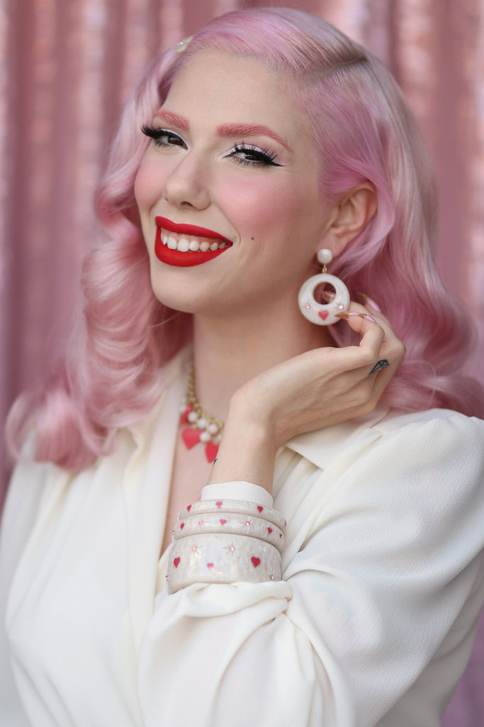 Splendette vintage inspired cute 1950s style carved white Sugar jewellery worn by pin up model Dafna Bar-El