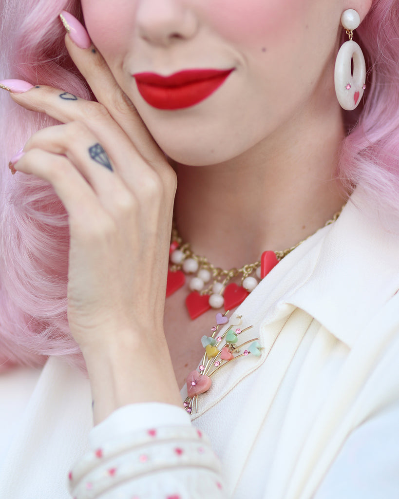 Splendette vintage inspired cute 1950s style carved white Sugar jewellery worn by pin up model Dafna Bar-El