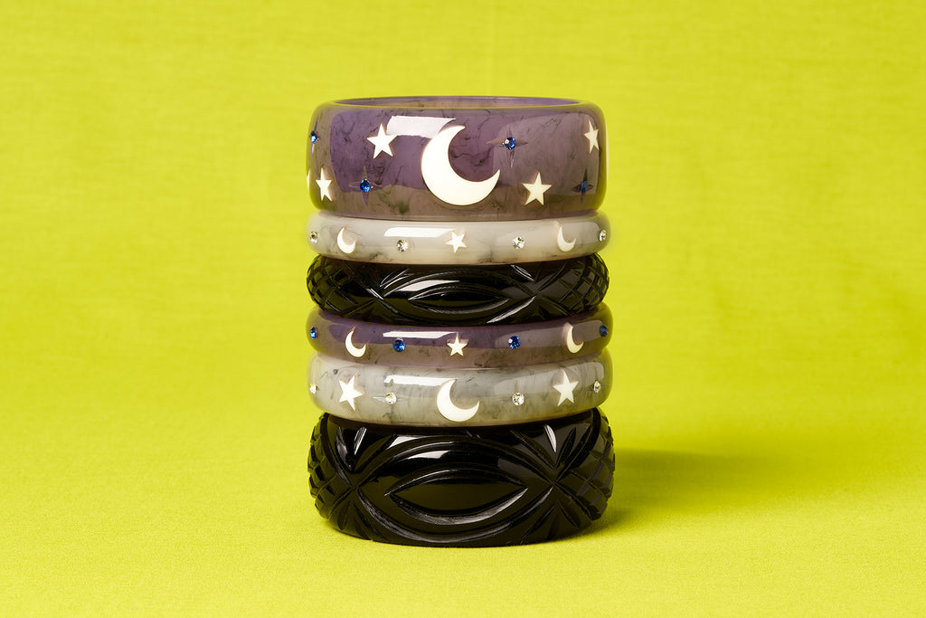 Splendette vintage inspired 1950s Halloween style Black, white Spectre and purple Poison bangles in a stack on a lime green background