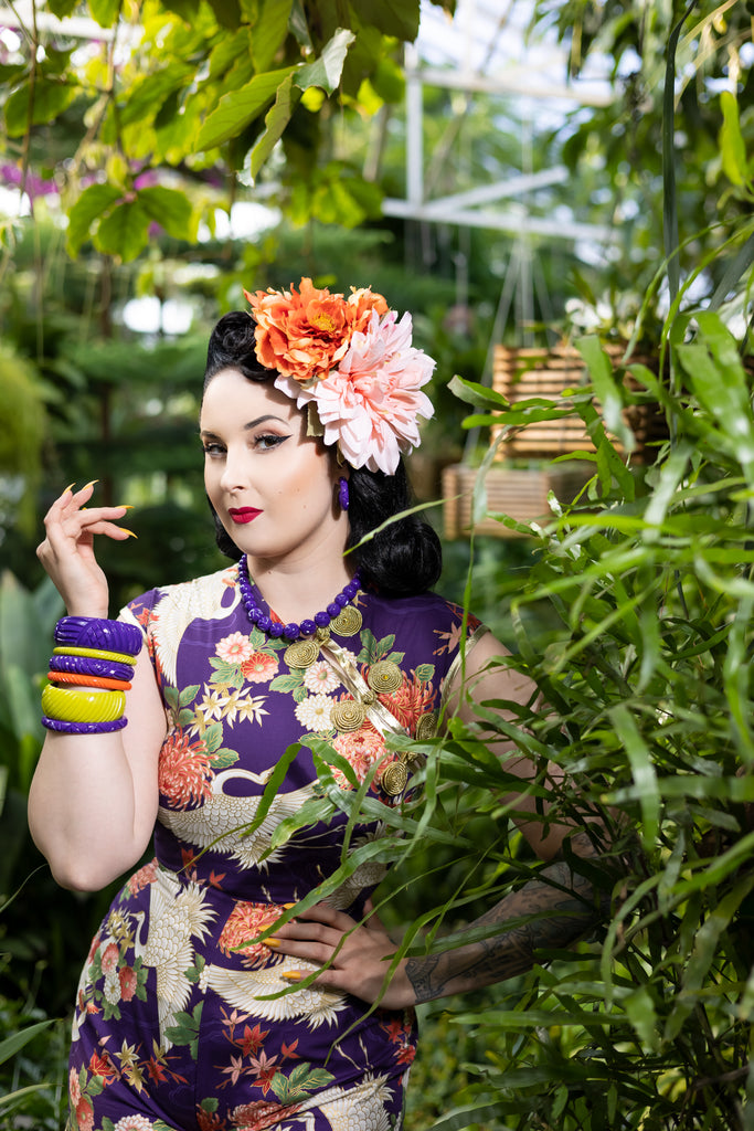 Splendette vintage inspired 1940s style purple Paradise Heavy Carve fakelite jewellery work by pin up model in tropical setting