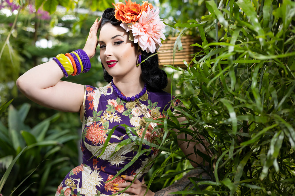 Splendette vintage inspired 1940s style purple Paradise Heavy Carve fakelite jewellery work by pin up model in tropical setting