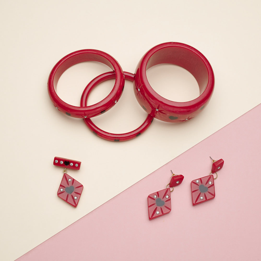 Splendette vintage inspired 1950s Valentine's style red Heartthrob Starburst fakelite jewellery flat lay with bangles, earrings and brooch