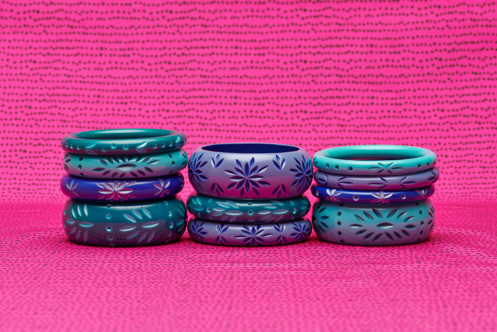 Splendette vintage inspired 1950s style Spring 2021 stack of three Duotone fakelite carved bangles in blue Forget-Me-Not and Cornflower with turquoise Dragonfly and Nymph in three stacks with bright pink background