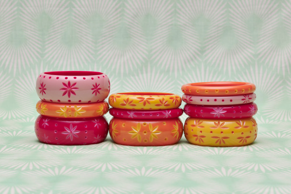 Splendette vintage inspired 1950s style bright carved Duotone fakelite bangles in three stacks. Soft pink Ripple, bright pink Raspberry, peachy orange Freesia and yellow Honeysuckle
