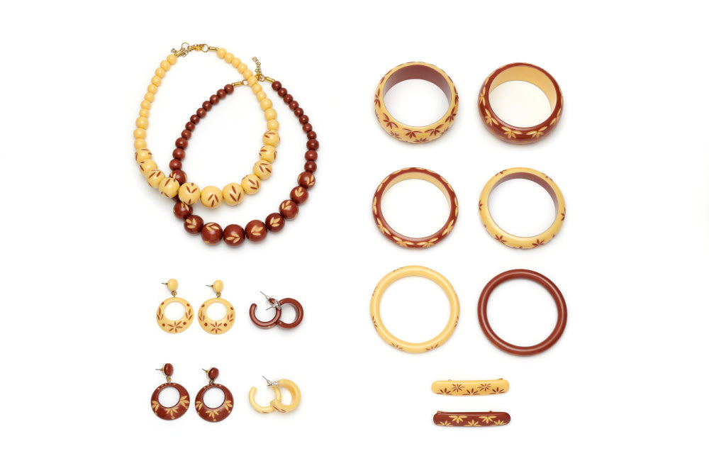 Splendette vintage inspired 1950s style cream and brown carved Fakelite Duotone jewellery flat lay with bangles, earrings, hair barrettes and bead necklaces