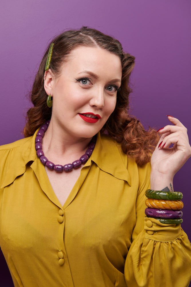 Splendette vintage inspired 1940s Bakelite style Golden Autumn model shot with fakelite jewellery. Plum, Olive and Mustard bangles with Plum necklace close up
