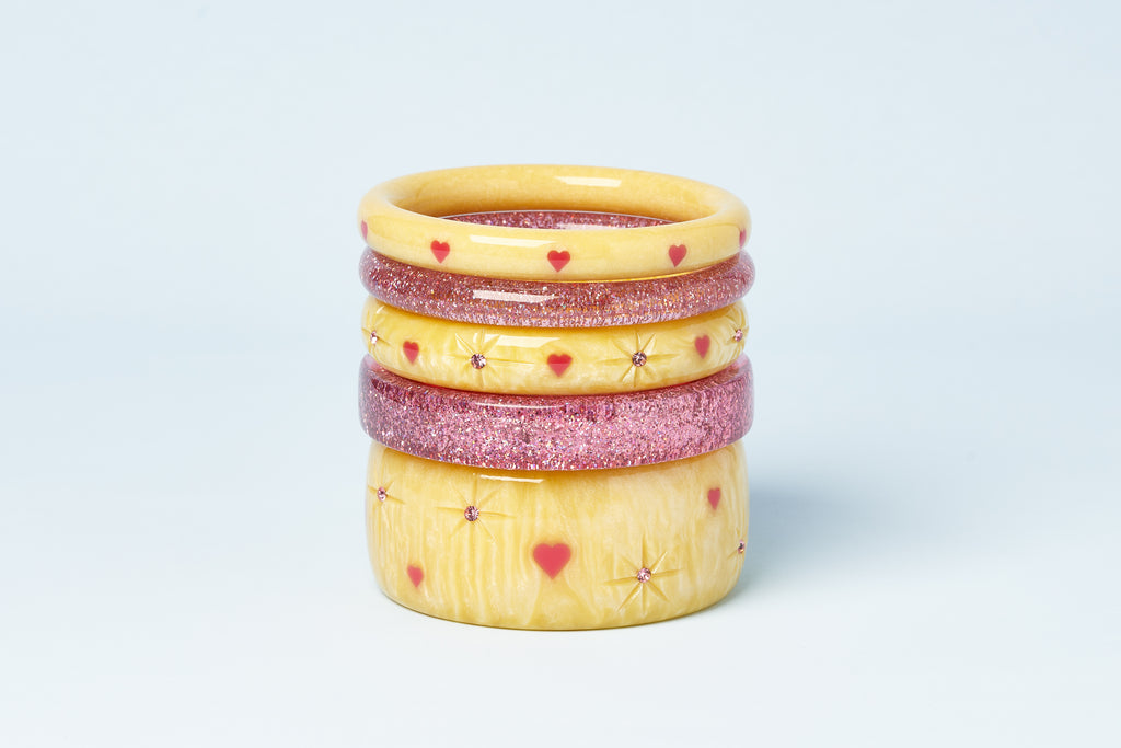 Splendette vintage inspired 1950s kitsch Valentine's style carved pastel yellow Honey Bunch bangles stacked with Pale Pink Glitter bangles